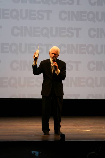 Mr. MARTIN COOPER shows the audience the first cell phone