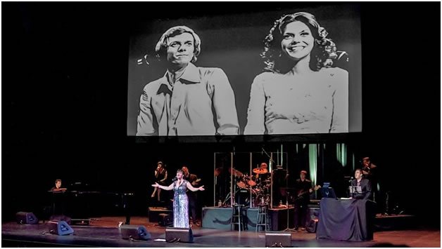 MICHELLE singing and  RICHARD & KAREN CARPENTER  in a projection