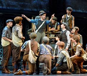 The newsies with Jack (de LUCA) at center, persuading them to strike.