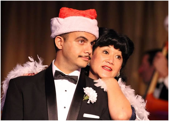 Mohamed Ismail as Santa and Irene Trapp singing “Santa Baby”
